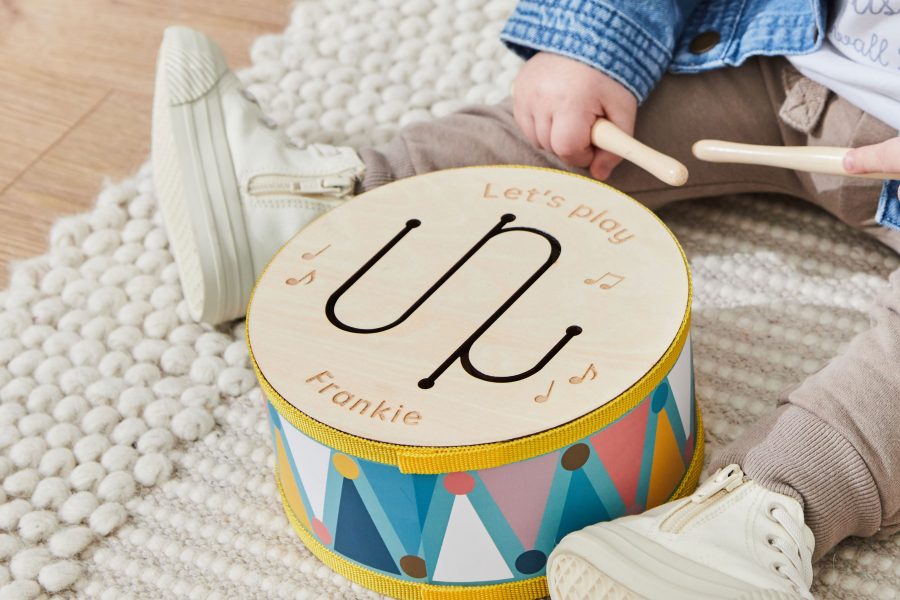 Baby sat playing with toy drum
