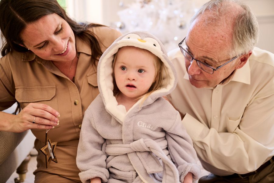 Baby in robe with Grandparents