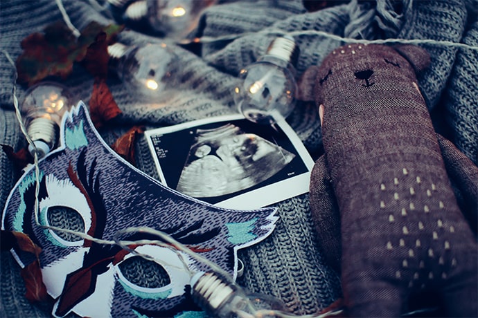 teddy bear and photograph on blanket