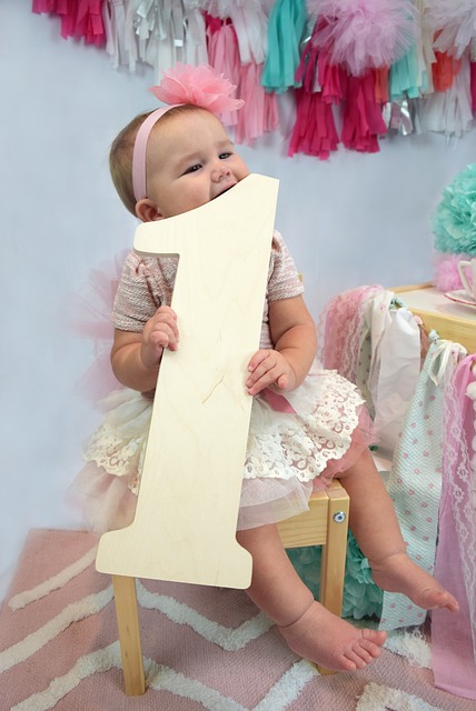 baby holding a giant number 1